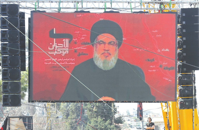 EBANON’S HEZBOLLAH leader Sayyed Hassan Nasrallah addresses his supporters through a televised speech in Baalbeck, Lebanon, last year. (photo credit: AZIZ TAHER/REUTERS)