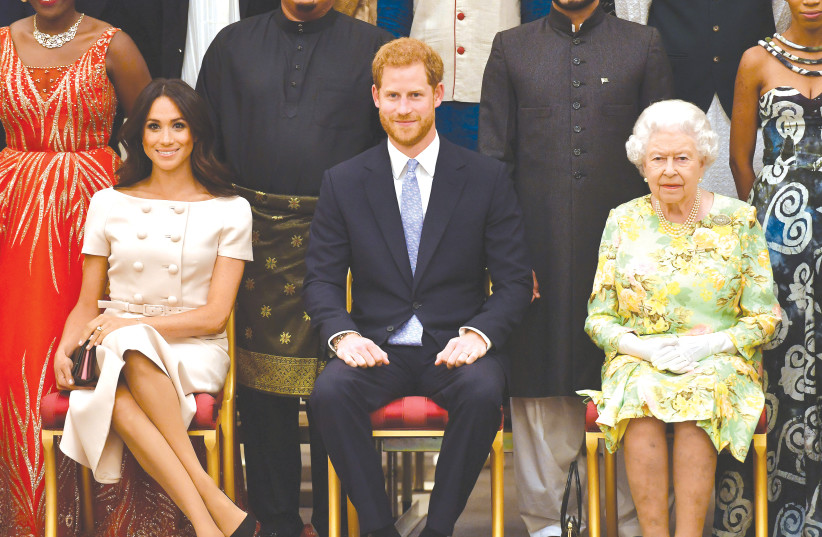 IN HAPPIER TIMES, Britain’s Queen Elizabeth, Prince Harry and Meghan, the Duchess of Sussex, pose for a picture in London.  (photo credit: JOHN STILLWELL / POOL / VIA REUTERS)