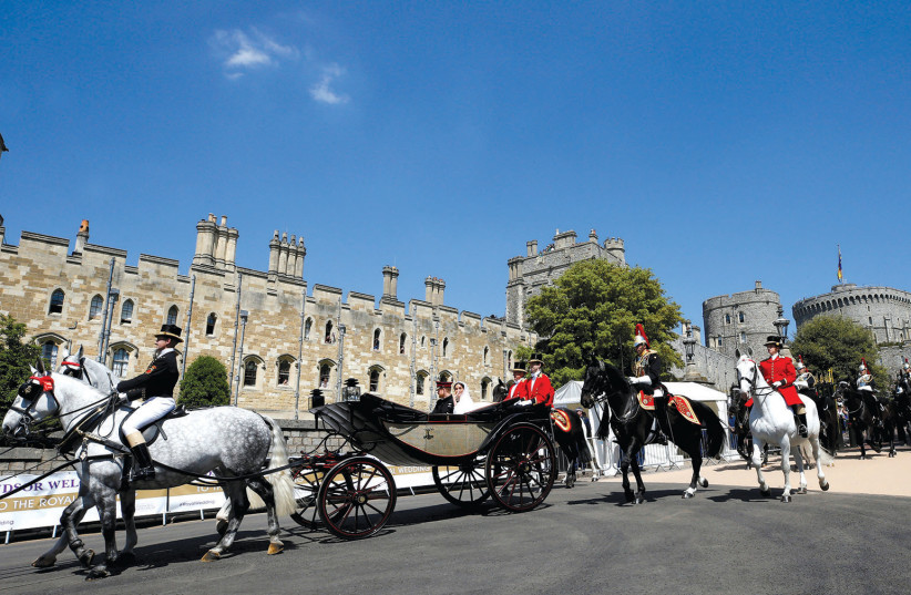 PRINCE HARRY And Meghan Markle ride a horse-drawn carriage after their wedding ceremony at St. George’s Chapel in Windsor in May 2018 (photo credit: PHIL NOBLE/REUTERS)