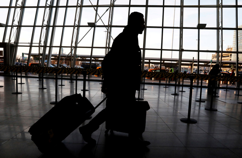 FILE PHOTO: International travelers arrive at John F. Kennedy international airport in New York City, U.S., February 4, 2017. The United States is screening visitors from Wuhan, China at JFK and at airports in Los Angeles and San Francisco for people who may have symptoms of a new virus (photo credit: REUTERS/BRENDAN MCDERMID/FILE PHOTO)