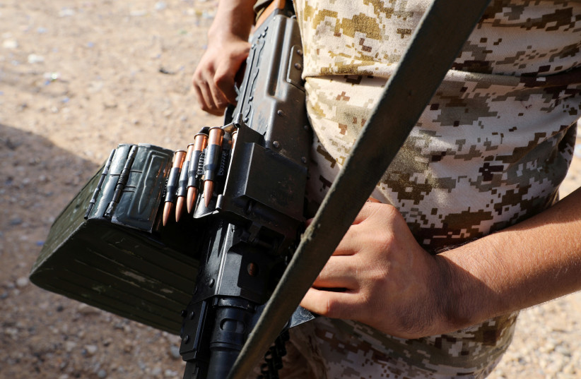 A member of Libya's internationally recognised government forces carries a weapon in Ain Zara, Tripoli, Libya October 14, 2019. Picture taken October 14, 2019.  (photo credit: ISMAIL ZITOUNY/ REUTERS)