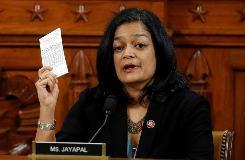 Rep. Pramila Jayapal. D-Wash, holds a copy of the U.S. Constitution as she votes to approve the second article of impeachment against President Donald Trump during a House Judiciary Committee meeting on Capitol Hill, in Washington, U.S., December 13, 2019 (photo credit: PATRICK SEMANSKY/POOL VIA REUTERS)