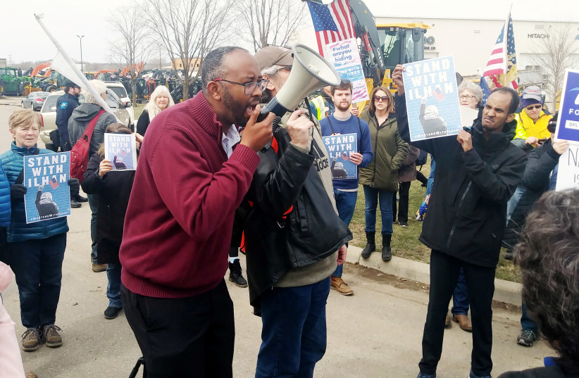 Jaylani Hussein, executive director of the Council on American-Islamic Relations (CAIR), Minnesota, speaks at a rally ahead of a visit by President Trump in Burnsville, Minnesota, U.S. April 15, 2019 (photo credit: REUTERS/JOEY PETERS)