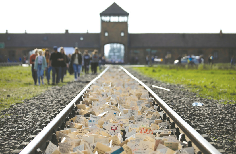 ‘March of the Living’ participants leave notes on the tracks leading to the former German Nazi Auschwitz concentration camp near Oswiecim, Poland, May 2, 2019. (photo credit: REUTERS/KACPER PEMPEL)
