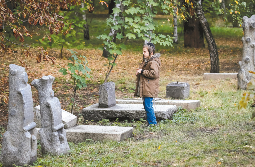 A boy visits a monmument commemorating the victims of Babi Yar in September. (photo credit: GLEB GARANICH/REUTERS)