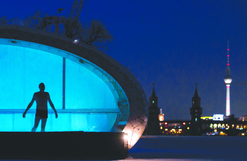 A MAN uses a sauna located at the frozen river Spree in Berlin (photo credit: REUTERS)