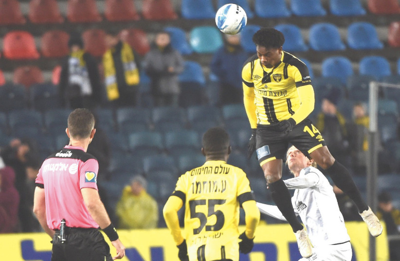 BEITAR JERUSALEM forward Levi Garcia (top) scored a pair of goals on Monday night in the yellow-and-black’s 3-1 home victory over Maccabi Netanya in Premier League action (photo credit: BERNEY ARDOV)