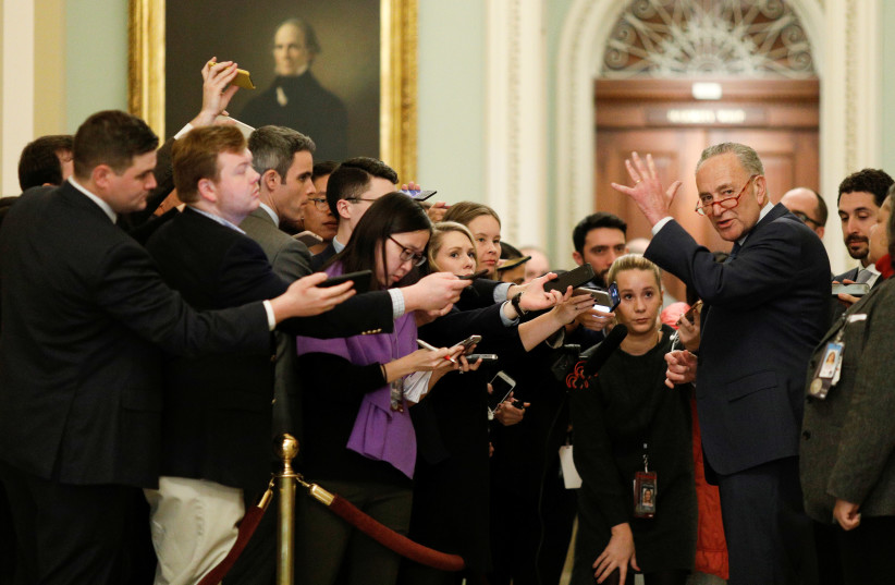 U.S. Senate Minority Leader Chuck Schumer (D-NY) speaks to members of the news media during the Senate Impeachment trial of U.S. President Donald Trump on Capitol Hill in Washington, U.S., January 21, 2020. (photo credit: REUTERS//TOM BRENNER)