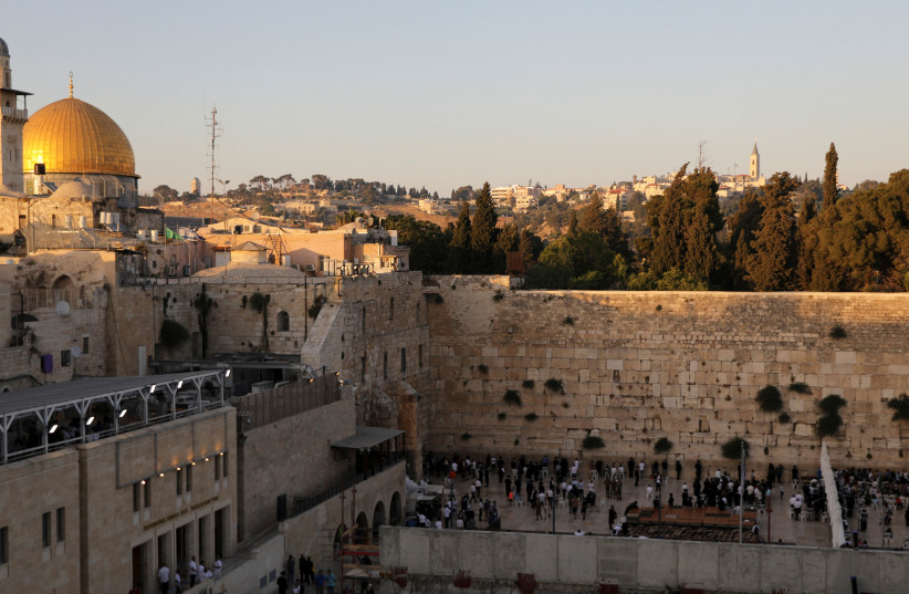 A general view of Jerusalem's Old City shows the Western Wall, Judaism's holiest prayer site, in the foreground and the Dome of the Rock, located on the compound known to Muslims as Noble Sanctuary and to Jews as Temple Mount, in the background June 24, 2019 (photo credit: AMMAR AWAD / REUTERS)