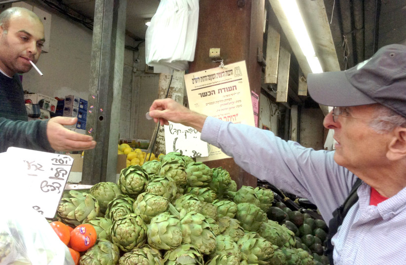 THE HEART of the matter: Purchasing artichokes at Jerusalem’s Mahaneh Yehuda market (photo credit: MICHELLE GORDON)