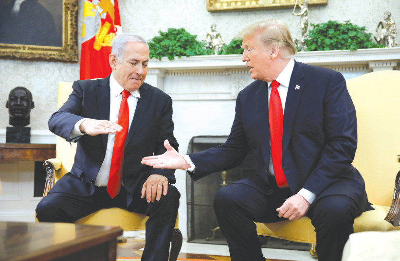 US PRESIDENT Donald Trump greets Prime Minister Benjamin Netanyahu at the White House last year (photo credit: REUTERS/CARLOS BARRIA)