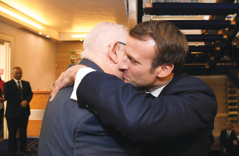 PRESIDENT REUVEN RIVLIN and French President Emmanuel Macron share a warm embrace on Wednesday in Jerusalem (photo credit: HAIM ZACH/GPO)