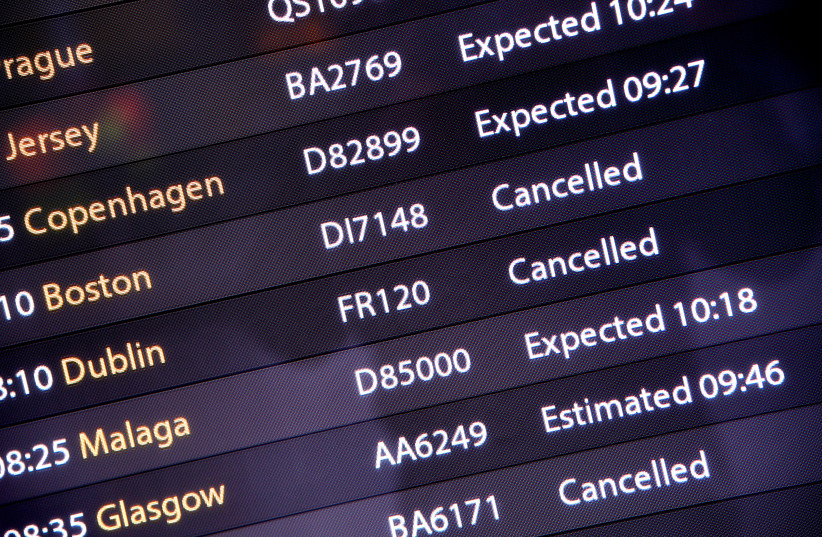 An arrivals board in the South Terminal building at Gatwick Airport, after the airport reopened to flights following its forced closure because of drone activity, in Gatwick, Britain, December 21, 2018 (photo credit: REUTERS/TOBY MELVILLE)
