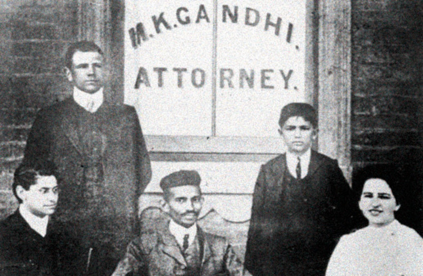 Mohandas Gandhi at his law office in Johannesburg (now called Gandhi Square), with his Jewish secretary Sonja Schlesin on one side and Henry Polak on the other (photo credit: Wikimedia Commons)