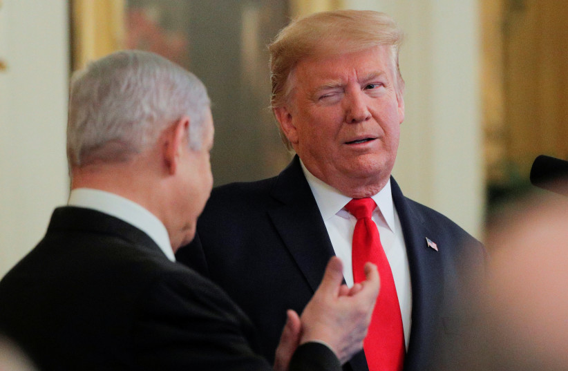 U.S. President Donald Trump winks at Israel's Prime Minister Benjamin Netanyahu as they discuss a Middle East peace plan proposal during a joint news conference in the East Room of the White House in Washington, U.S., January 28, 2020 (photo credit: REUTERS/BRENDAN MCDERMID)