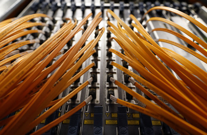 Cables of optical fibre of Telecom Italia are seen in a telephone exchange in Rome (photo credit: REUTERS)