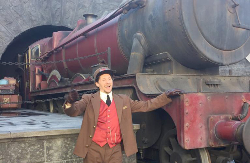 A MAKE-BELIEVE conductor poses before an imaginary trip to Hogwarts. . (photo credit: SUSSIE WEISS)