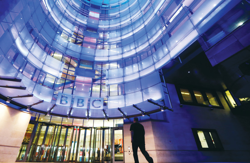 A MAN ENTERS BBC’s New Broadcasting House in London (photo credit: LUKE MACGREGOR / REUTERS)