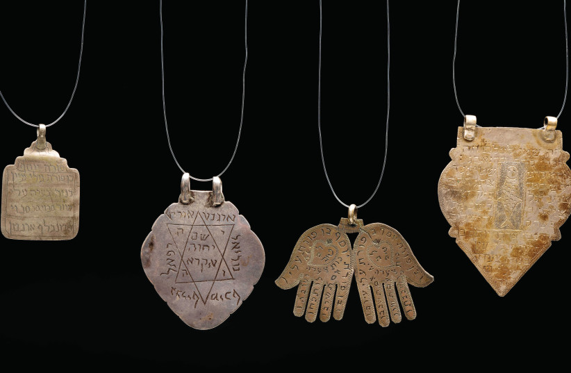 A COLLECTION of Jewish silver amulets sporting Hebrew text from Iran and Jerusalem, circa 1900. Both their form and writings were supposed to keep the wearer from harm. (photo credit: Courtesy)