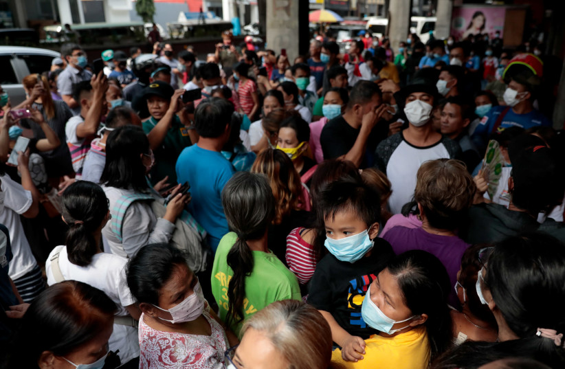 A queue outside a medical supply store that sells face masks, a day after the first novel coronavirus case, in Manila, Philippines (photo credit: REUTERS/ELOISA LOPEZ)