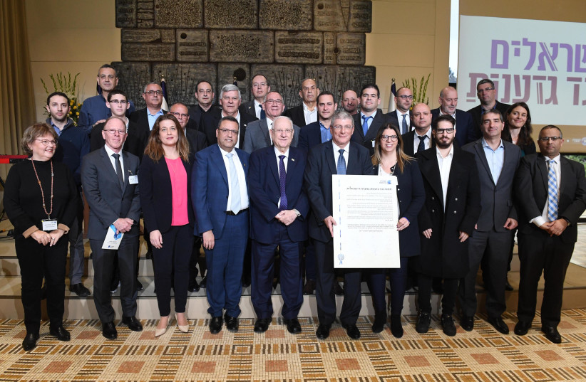 President Reuven Rivlin surrounded by the signatories who convened at the President's Residence on Sunday, to sign an anti-racism pact initiated by Israelis Against Racism, February 2, 2020 (photo credit: MARK NEYMAN/GPO)