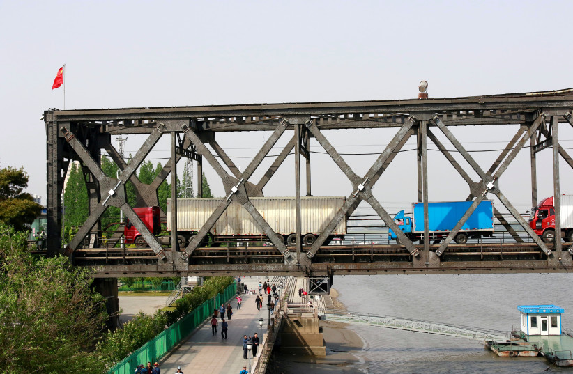 Trucks wait for border inspection at the Chinese end of the Friendship Bridge (photo credit: REUTERS)