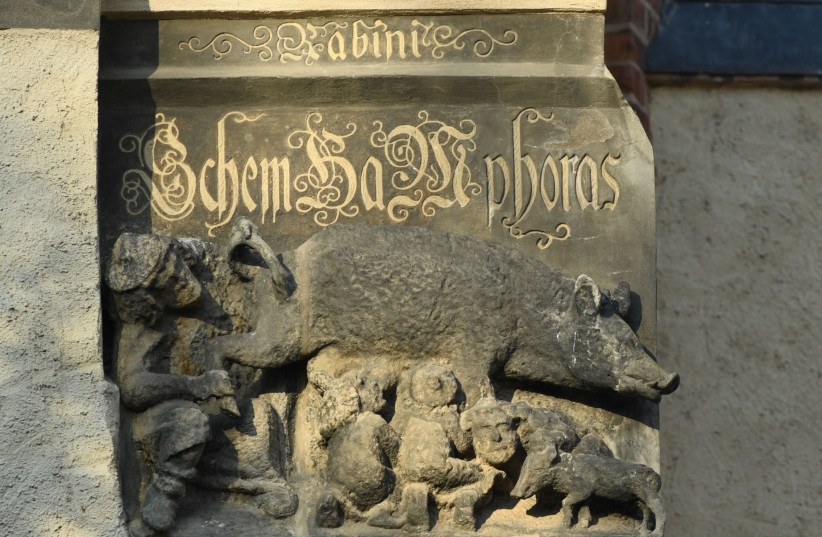 A thirteenth century anti-Semitic sculpture is displayed at St. Marien church in Wittenberg, Germany, January 24, 2020. A court is expected to rule on a motion seeking the removal of the 700-year-old sculpture known as “Judensau” or Jew pig. It is one of around 20 such relics from the Middle Ages th (credit: ANNEGRET HILSE / REUTERS)