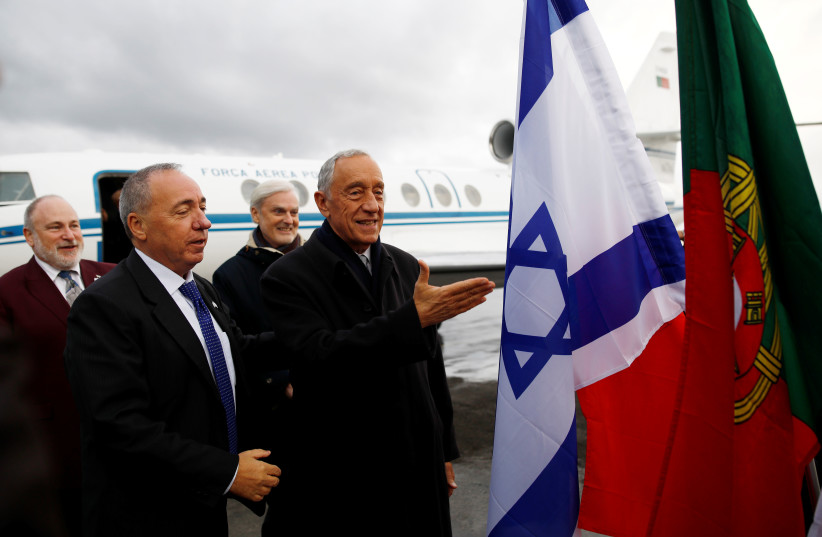Portugal's President Marcelo Rebelo de Sousa gestures near national flags of Israel and Portugal upon landing at Ben Gurion International Airport to take part in a Yad Vashem Holocaust memorial event (credit: CORINNA KERN/REUTERS)