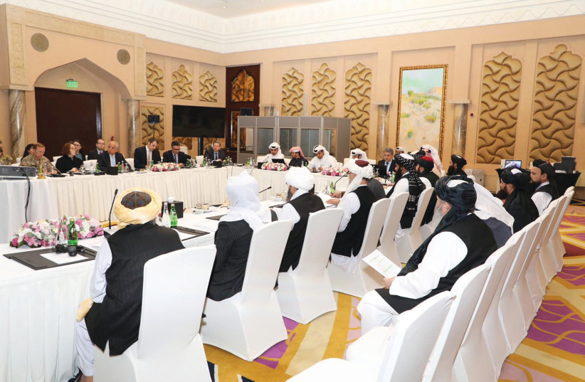 US, Taliban and Qatari officials during a meeting for peace talks in Doha. (photo credit: REUTERS)
