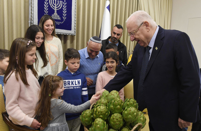 President Reuven Rivlin with three generations of artichokes growers (photo credit: Mark Neiman/GPO)