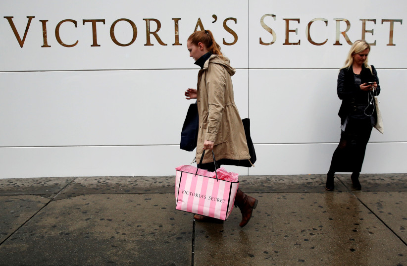 A customer passes by an L Brands Inc., Victoria's Secret retail store in Manhattan, New York (photo credit: BRENDAN MCDERMID/REUTERS)