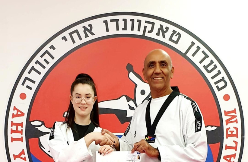 Encouraged by her coach Avi Kadouri, Amit receives her black belt (photo credit: RUBENS ZADEL)