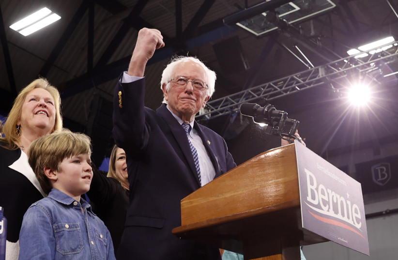 Democratic U.S. presidential candidate Senator Bernie Sanders is accompanied by his wife Jane O’Meara Sanders and other relatives as he speaks at his New Hampshire primary night rally in Manchester, N.H., U.S., February 11, 2020 (photo credit: REUTERS/MIKE SEGAR)