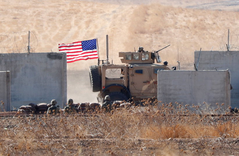 A US military vehicle is pictured behind the Turkish border walls during a joint US-Turkey patrol in northern Syria, 2019 (photo credit: MURAD SEZER/REUTERS)