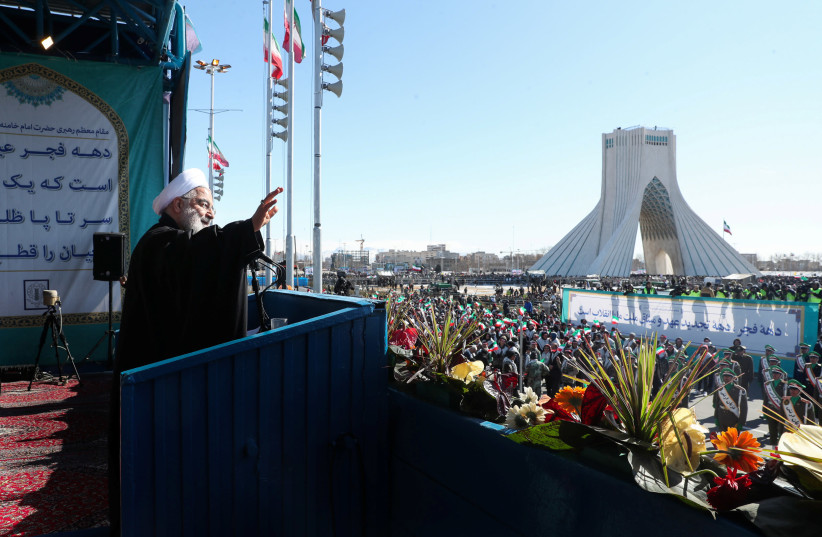 Iranian President Hassan Rouhani salutes the crowd during the commemoration of the 41st anniversary of the Islamic revolution in Tehran, Iran February 11, 2020 (photo credit: OFFICIAL PRESIDENT WEBSITE/HANDOUT VIA REUTERS)
