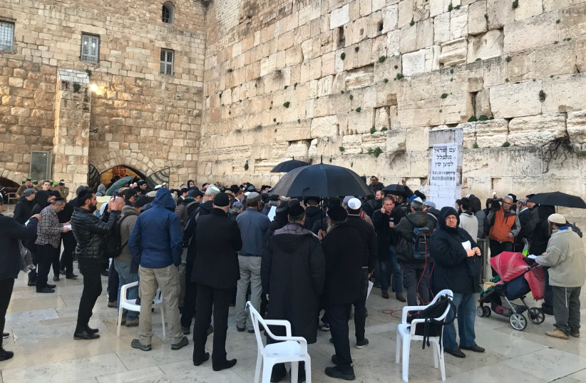 Dozens gathered at the Western Wall on February 16, 2020 to pray for those affected by the coronavirus outbreak. (photo credit: ROSSELLA TERCATIN)