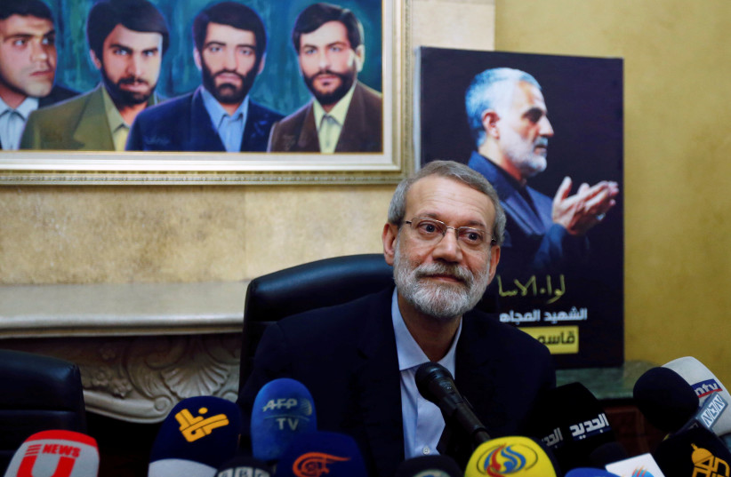 Iranian parliament speaker Ali Larijani attends a news conference at the Iranian embassy in Beirut's southern suburbs, as a picture of late Iran's Quds Force top commander Qassem Soleimani is seen in the background, Lebanon February 17, 2020.  (photo credit: REUTERS)
