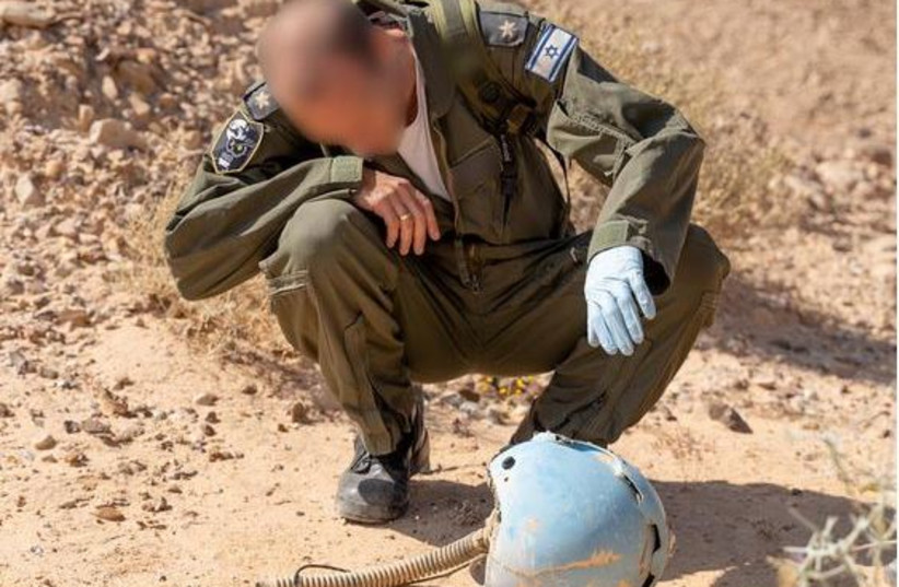 IAF soldier inspect helmet of missing pilot Danny Gori.  (photo credit: IDF)