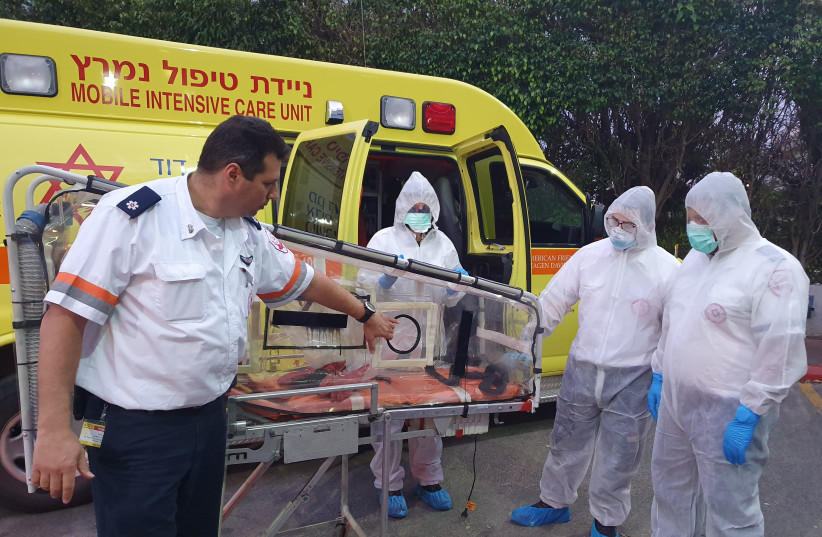 Magen David Adom paramedics are seen wearing special protective suits and preparing to evacuate Israelis returing from the 'Diamond Princess' crusie ship. (photo credit: MDA)