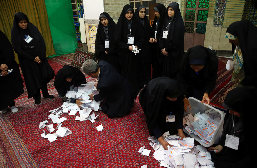 Poll workers empty full ballot boxes after the parliamentary election voting time ended in Tehran, Iran February 22, 2020 (photo credit: NAZANIN TABATABAEE/WANA (WEST ASIA NEWS AGENCY) VIA REUTERS)