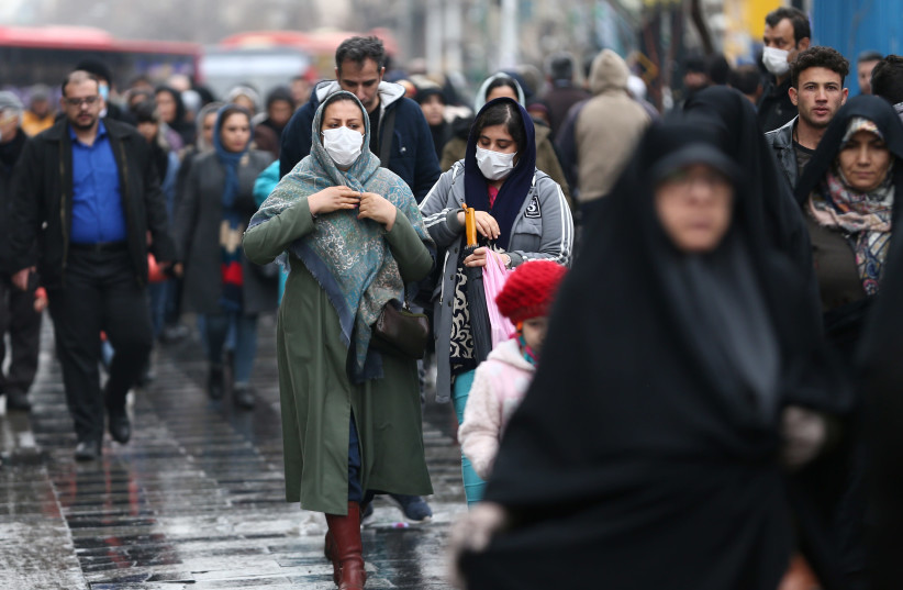 Iranian women wear protective masks to prevent contracting a coronavirus, as they walk at Grand Bazaar in Tehran, Iran February 20, 2020 (photo credit: WANA (WEST ASIA NEWS AGENCY)/NAZANIN TABATABAEE VIA REUTERS)
