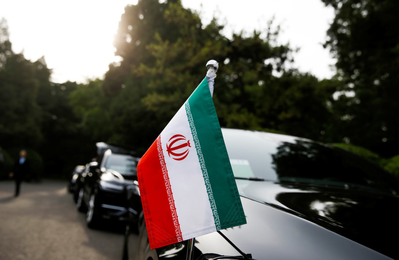 Cars of the Iranian delegation are parked outside a building of the at Diaoyutai state guesthouse in Beijing, 2018 (photo credit: THOMAS PETER/REUTERS)
