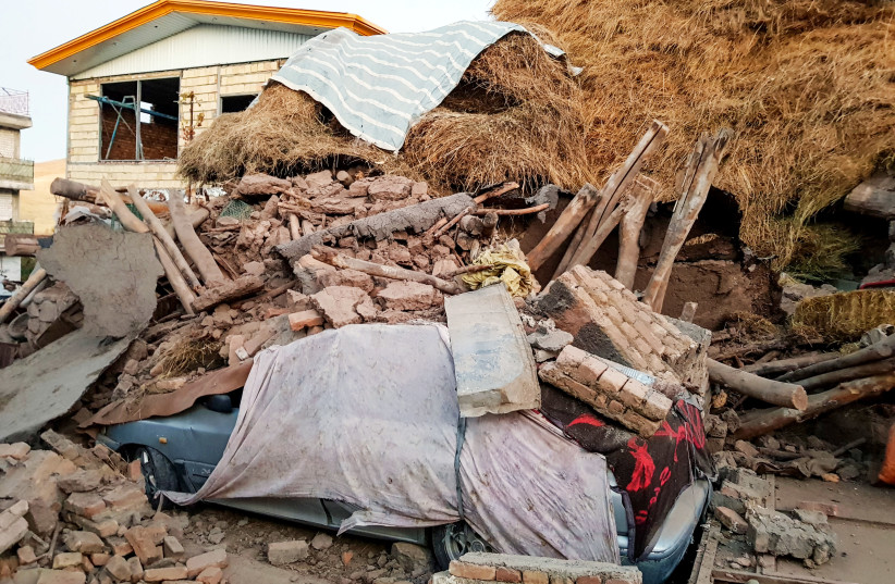 A damaged car is seen under the ruins, after an earthquake hit the Varankesh village in Eastern Azerbaijan province, northwest of Tehran, Iran November 08, 2019 (credit: TASNIM NEWS AGENCY/WANA (WEST ASIA NEWS AGENCY) VIA REUTERS)