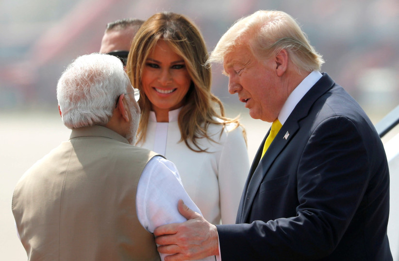 U.S. President Donald Trump and first lady Melania Trump are welcomed by Indian Prime Minister Narendra Modi as they arrive at Sardar Vallabhbhai Patel International Airport in Ahmedabad, India February 24, 2020 (photo credit: AL DRAGO/REUTERS)
