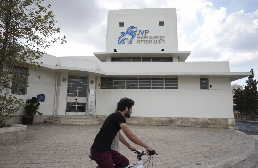 A man rides a bicycle past the offices of venture capital firm JVP in Jerusalem (photo credit: REUTERS)