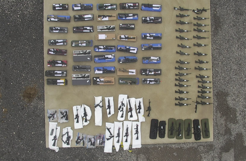 The airsoft guns found in the port of Ashdod next to the parts that could turn them into assault rifles  (photo credit: POLICE SPOKESPERSON'S UNIT)