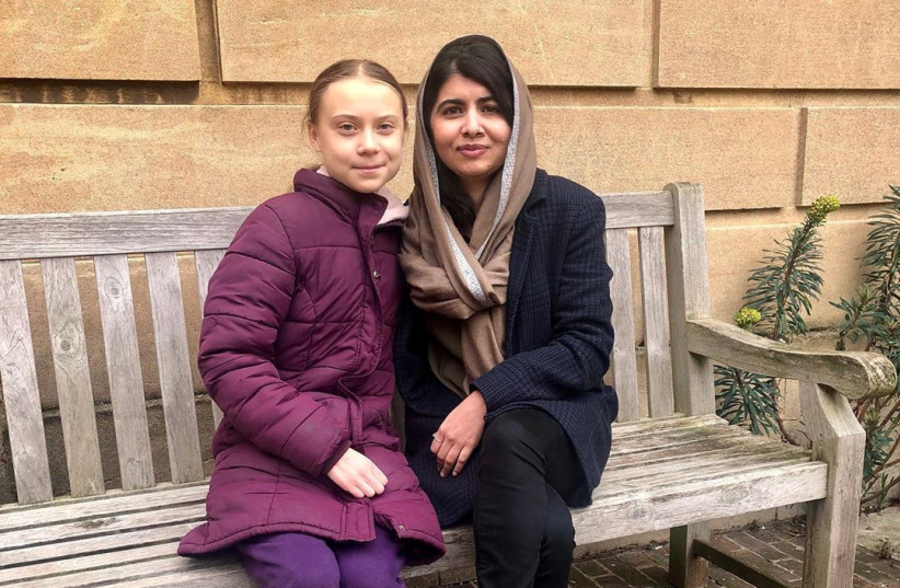 Swedish environmental activist Greta Thunberg meets Nobel Peace Prize winner Malala Yousafzai at University of Oxford (photo credit: REUTERS)