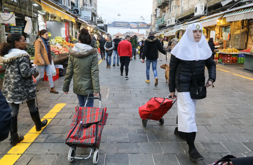 FOR SHUK shoppers of all stripes, it’s business as usual in daytime – despite the appearance of the contentious yellow line (photo credit: MARC ISRAEL SELLEM)