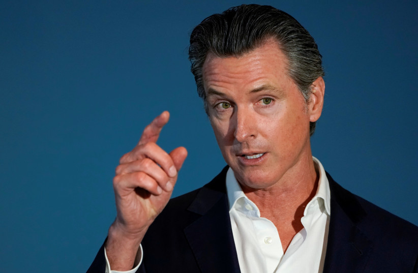 FILE PHOTO: California governor Gavin Newsom speaks at a news conference as he signs SB 113, which will enable the transfer of $331million in state funds to the National Mortgage Special Deposit Fund in San Diego, California, U.S. October 9, 2019 (photo credit: REUTERS/MIKE BLAKE/FILE PICTURE)