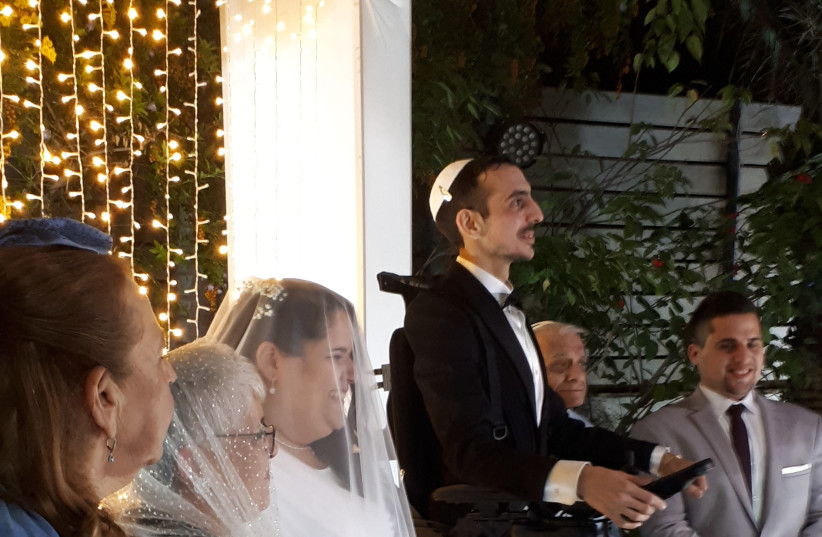 A man is seen getting married while using the UPnRIDE Robotic Standing Wheelchair. (photo credit: ALONI MOR)